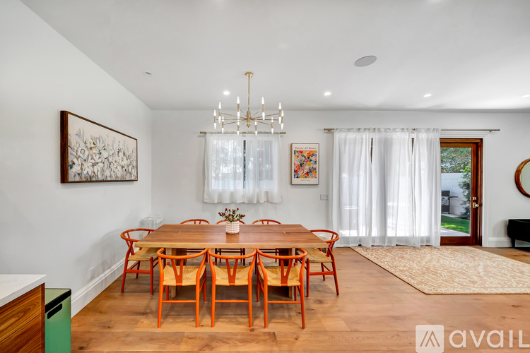 A dining room with a wooden table and chairs.
