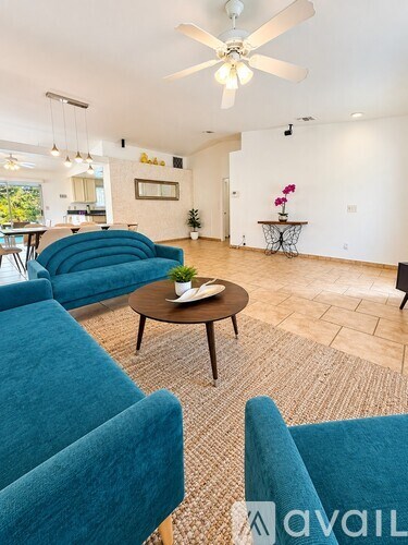 A living room with a blue couch and a coffee table.