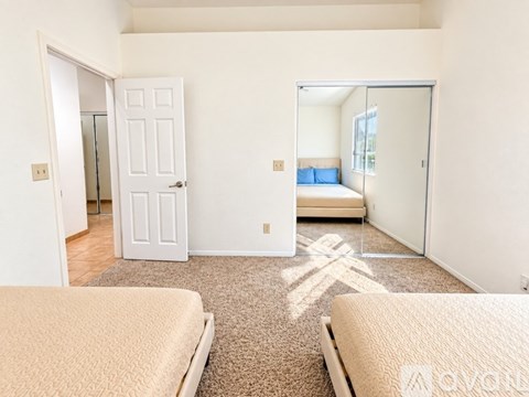A bedroom with two beds and a closet.