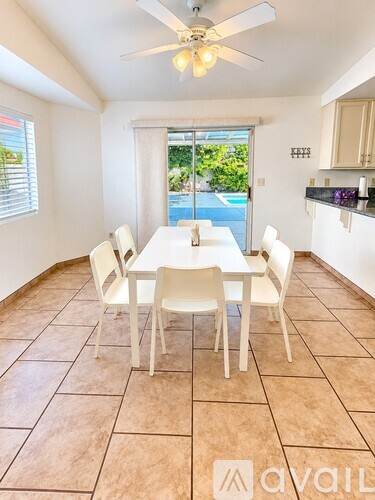 A dining room with a table and chairs.