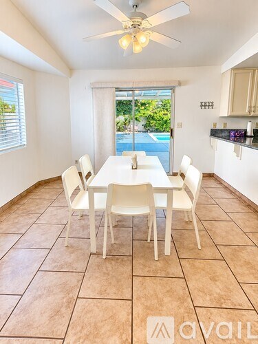 A dining room with a table and chairs.