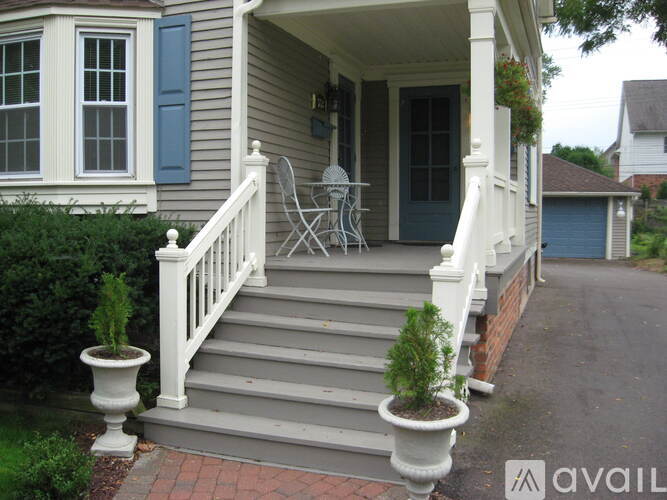 A house with a blue door and white railings.