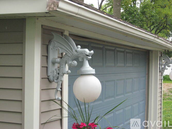 A white dragon head is mounted on a house.