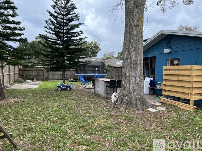 A blue house with a tree in front of it.