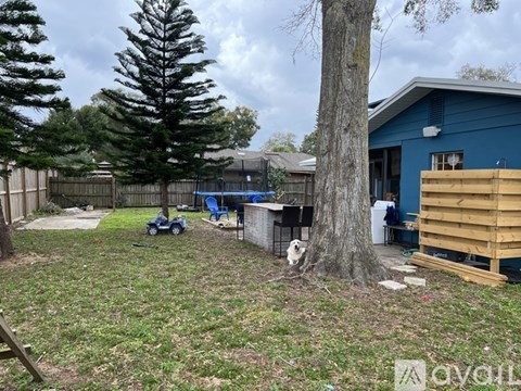 A blue house with a tree in front of it.