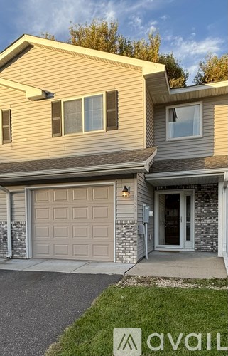 A house with a garage door and a driveway.