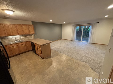 A kitchen with wooden cabinets and a tiled floor.