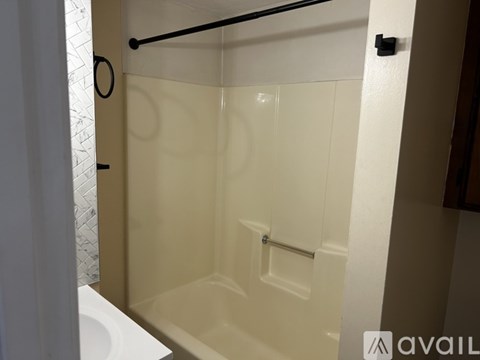 A bathroom with a white tub and a white toilet.