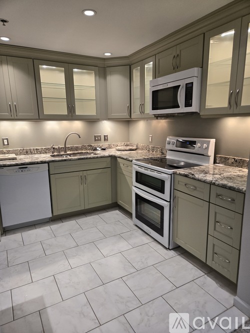 A kitchen with a white dishwasher and white oven.