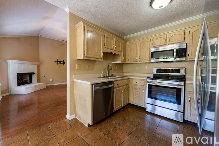 A kitchen with wooden cabinets and stainless steel appliances.