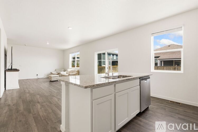 A spacious kitchen with white cabinets and a large island.