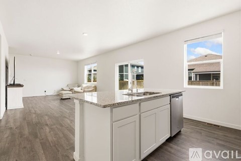 A spacious kitchen with white cabinets and a large island.