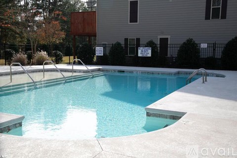 A pool with a diving board and a sign that says "available".