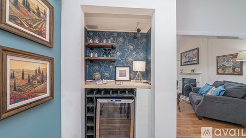 A living room with a fireplace and a painting on the wall.