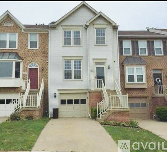 A row of houses with a garage door in the middle.