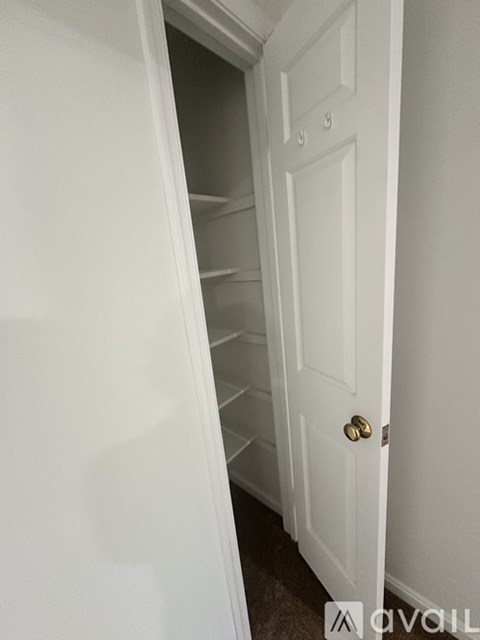 A white door is open to a hallway.
