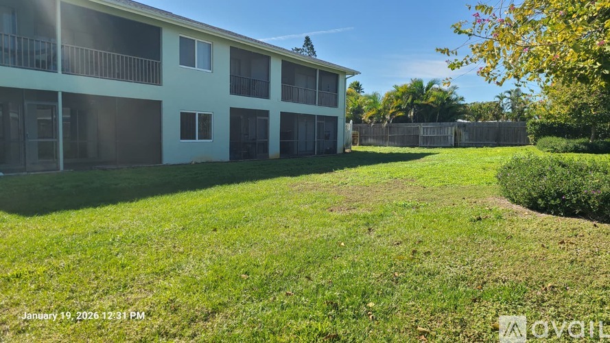 A sunny day at the apartment complex with a green lawn.