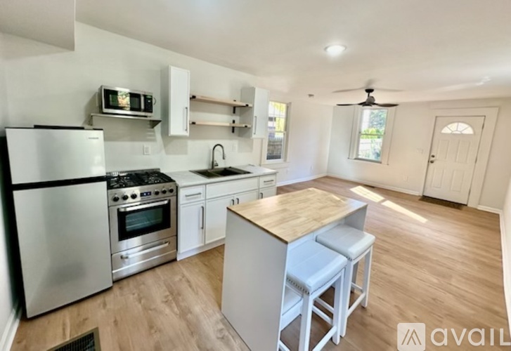 A kitchen with a refrigerator, stove, and oven.
