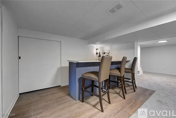 A dining area with a table and chairs.