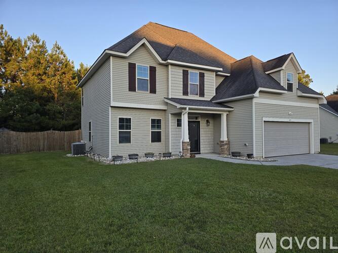 A house with a brown roof and a garage door.