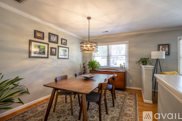 A dining room with a wooden table and chairs.