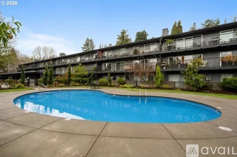 A swimming pool in front of apartment buildings.