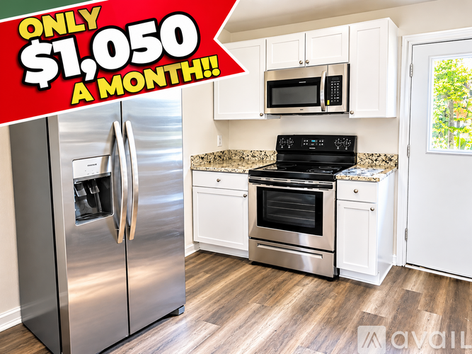 A kitchen with a stainless steel refrigerator and a black stove top oven.