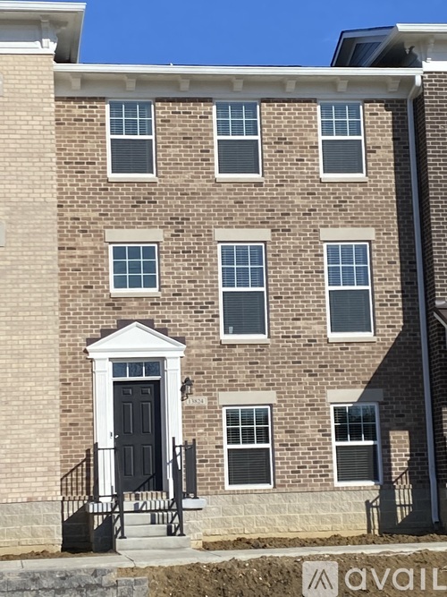 A brick building with a black door and windows.