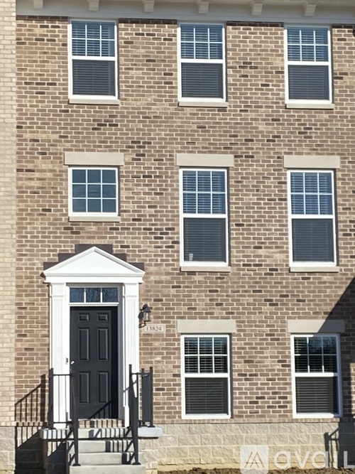 A brick building with a black door and windows.