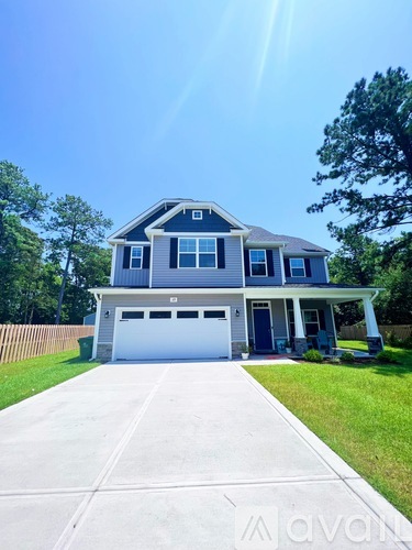A two-story house with a garage is shown in the image.