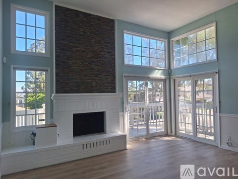 A living room with a fireplace and sliding glass doors.