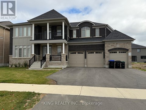 A large house with a driveway in front of it.