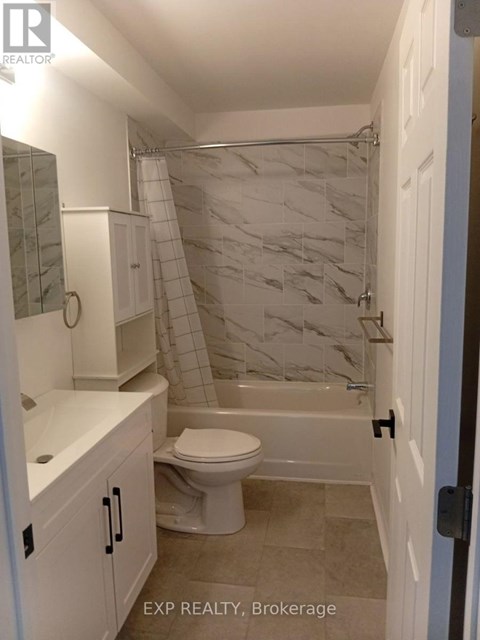 A kitchen area with a dining table and chairs in a room with EXP REALTY, Brokerage watermark.