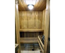 A wooden sauna with a bench and a heater.
