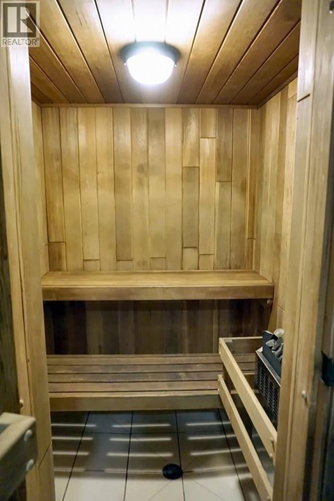 A wooden sauna with a bench and a heater.