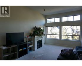 A living room with a fireplace and a television.