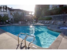 A pool with a ladder and a sunny day.