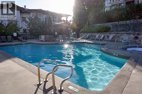 A pool with a ladder and a sunny day.