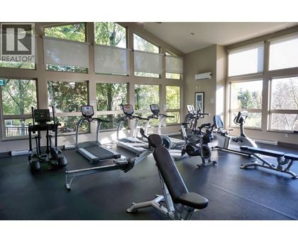 A gym with treadmills, elliptical machines, and other exercise equipment.