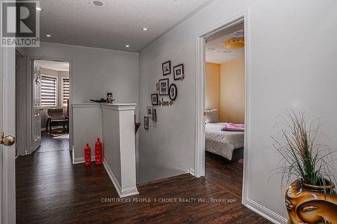 A bedroom with a bed, a dresser, and a mirror.