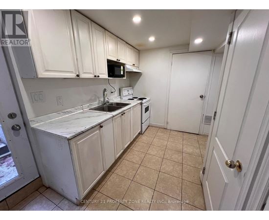 A kitchen with white cabinets and appliances.
