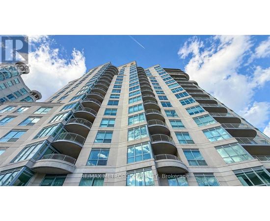 A tall building with balconies on each floor.