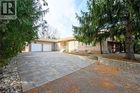 A house with a driveway and a garage is for sale.
