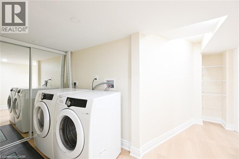 A laundry room with a row of washing machines.