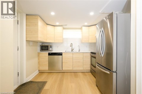 A modern kitchen with wooden cabinets and stainless steel appliances.
