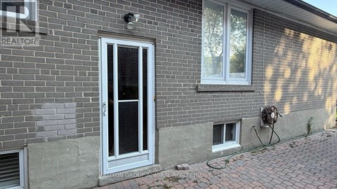 A brick house with a window and a door.