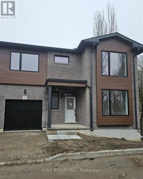 A house under construction with a brown and grey exterior.