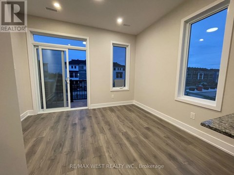A room with a view of a street through the windows.