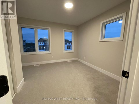 A room with a window and a view of buildings outside.