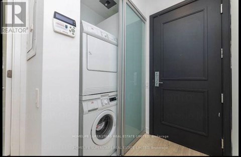 A laundry room with a washer and dryer stacked on top of each other.